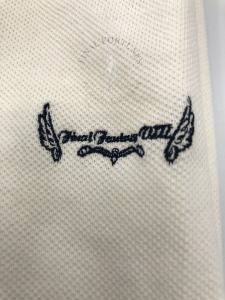 A close-up of the embroidery on the shirt. The words "Final Fantasy VIII" are flanked by Rinoa's wing symbol.