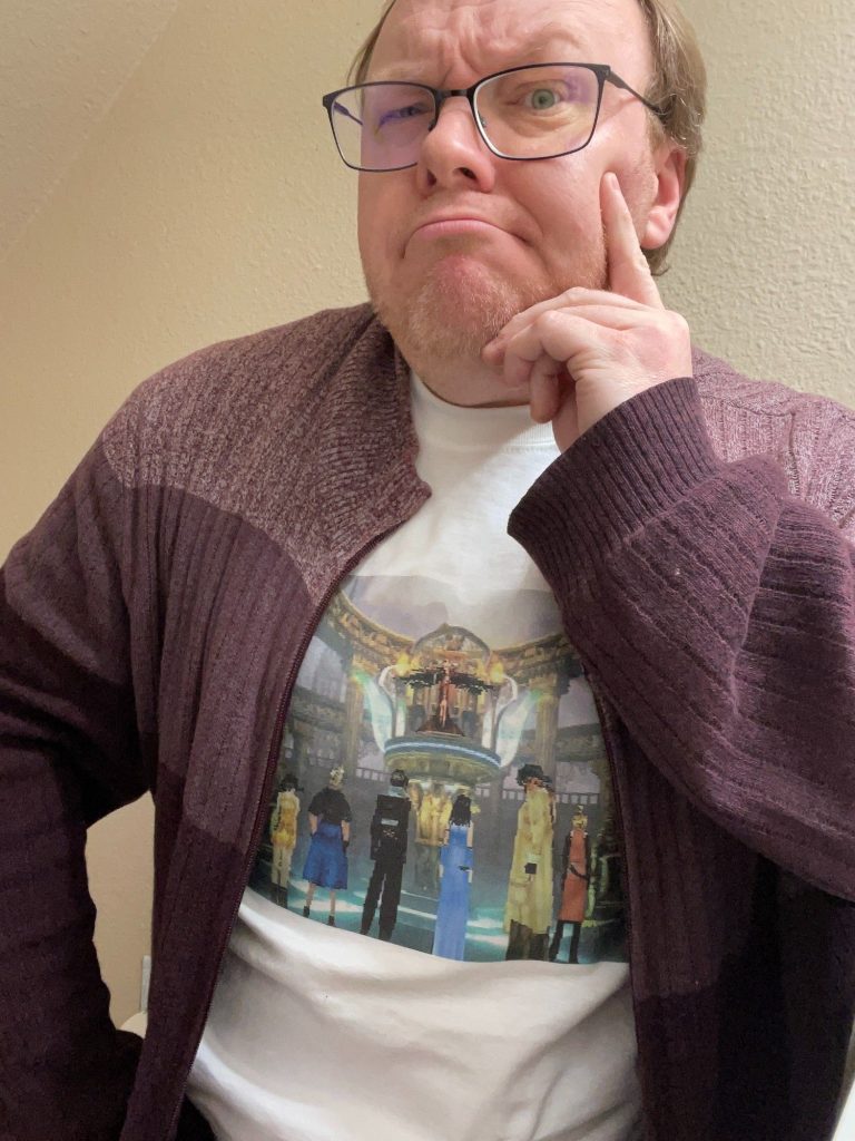 Phil Theobald wearing a t-shirt with a screenshot on it showing the Final Fantasy VIII party in Ultimecia's throne room.