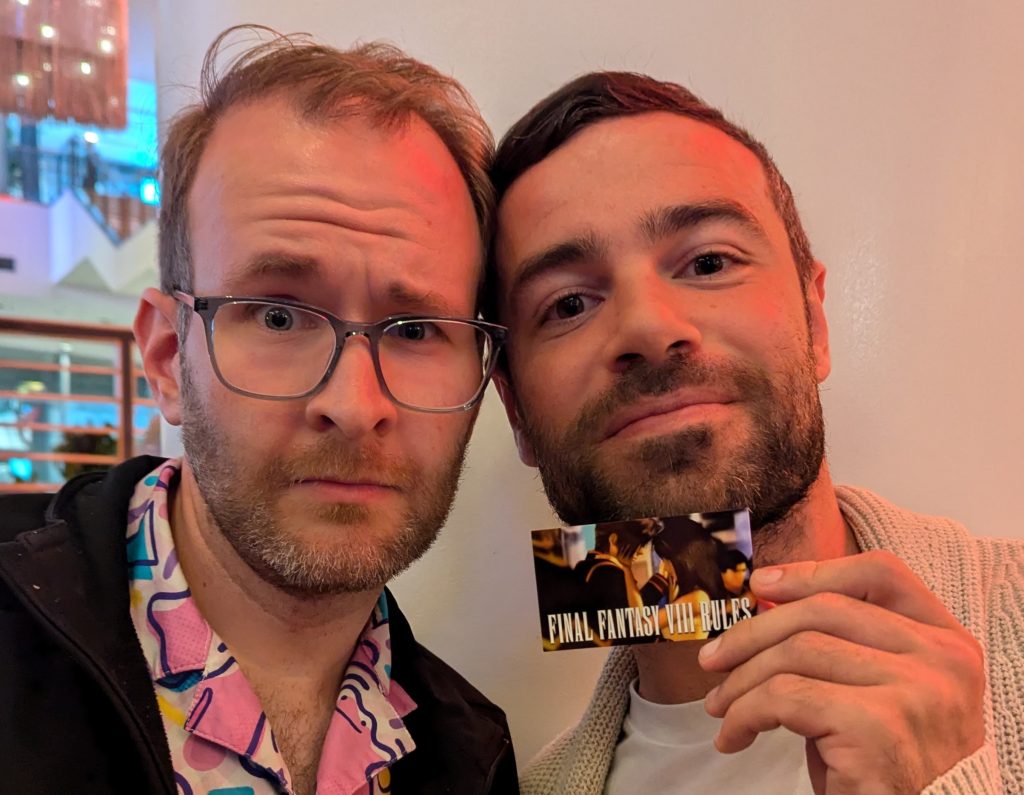 Me with Ben Starr, holding a card that says "Final Fantasy VIII rules."