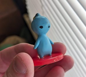 A tiny PuPu figurine. He's a little dirty.