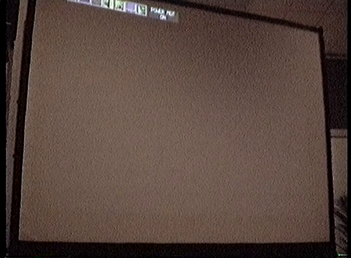 A projector screen with the projector's settings menu visible.